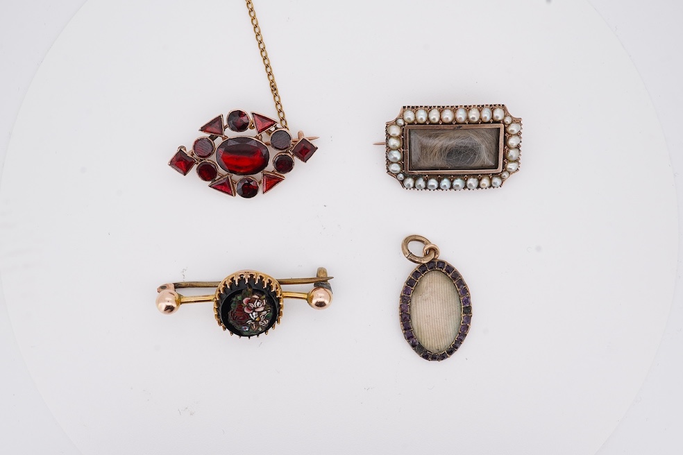 Three assorted Victorian brooches including a 9ct and garnet cluster by Murrle Bennett & Co, 27mm, a micro mosaic bar brooch and a yellow metal and split pearl mourning brooch, together with a gem set oval pendant. Condi
